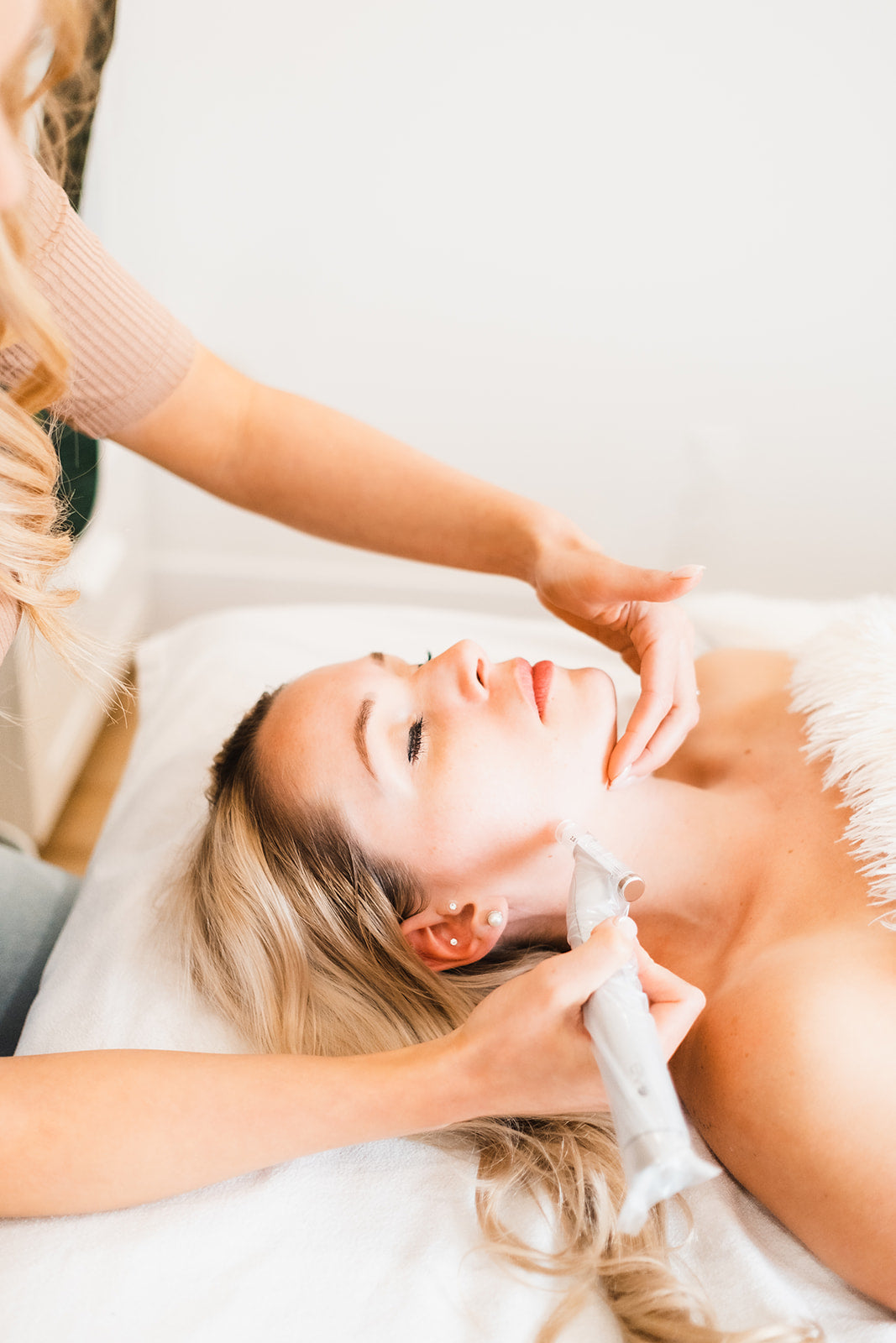 Dr. Allison Maloney skillfully administering a microneedling acupuncture treatment on a radiant woman's face, Fillers and injectable best alternative treatment