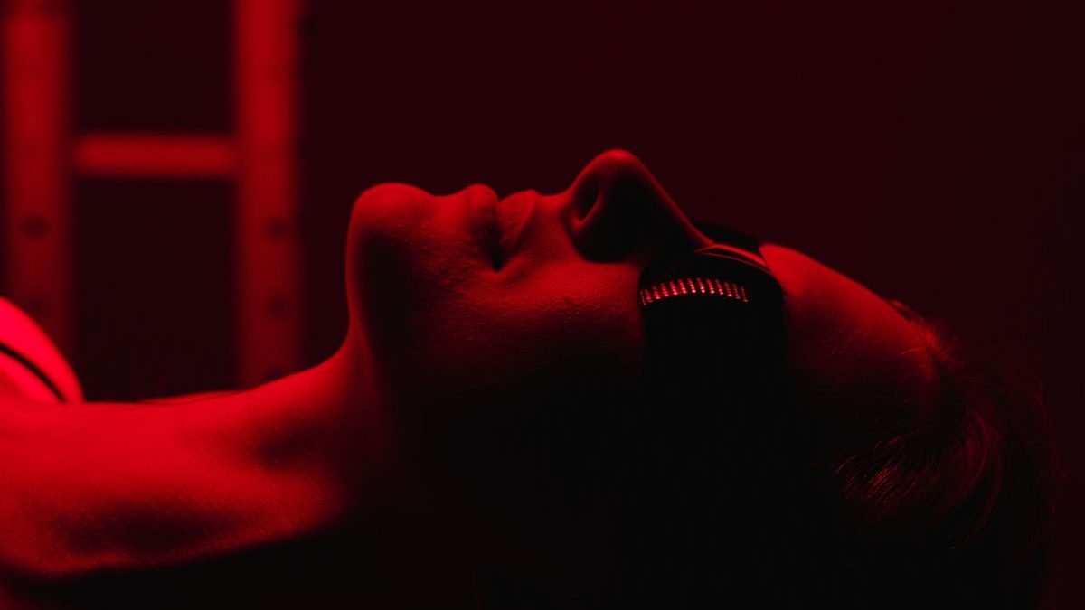 Close-up of a client wearing protective goggles during a red light therapy session